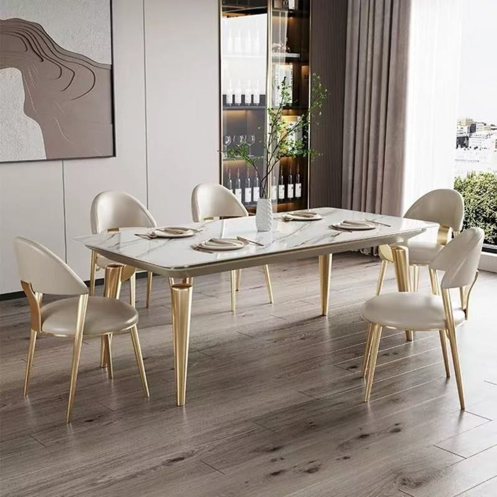 luxury dining table set ; modern dining furniture ; marble top table ; gold leg dining table ; 6-seater dining set ; contemporary dining room ;  elegant dining chairs ; upholstered dining chairs ; gold and white table set ; chic dining furniture