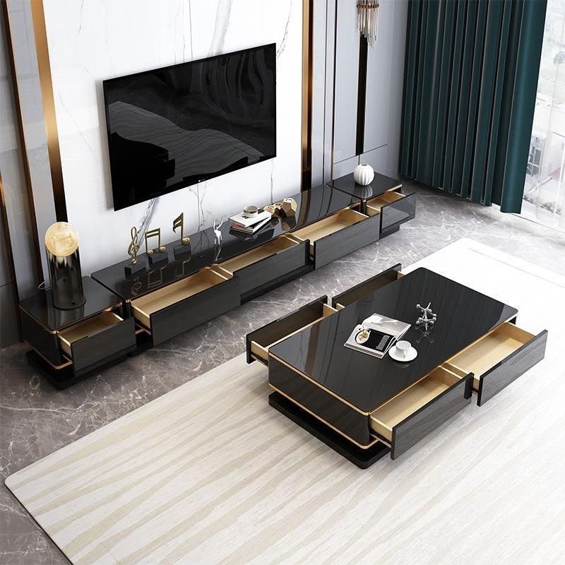 Luxury black living room furniture set featuring a TV console, coffee table, and two side tables with elegant gold trim and contemporary design.